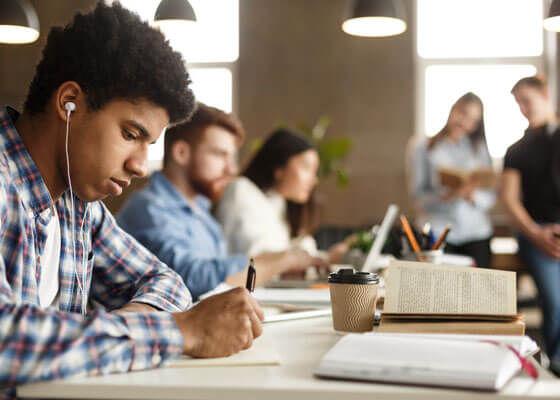Student Guy Doing Homework And Preparing For Exam